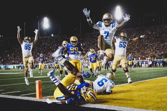 UCLA celebrates after a touchdown from RB Anthony Woods