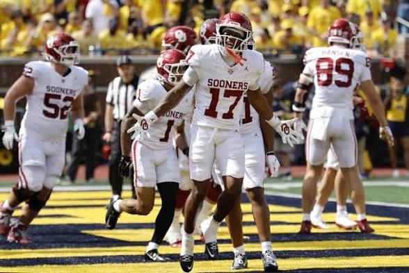 Oklahoma’s offense celebrating after the teams first Touchdown of the day